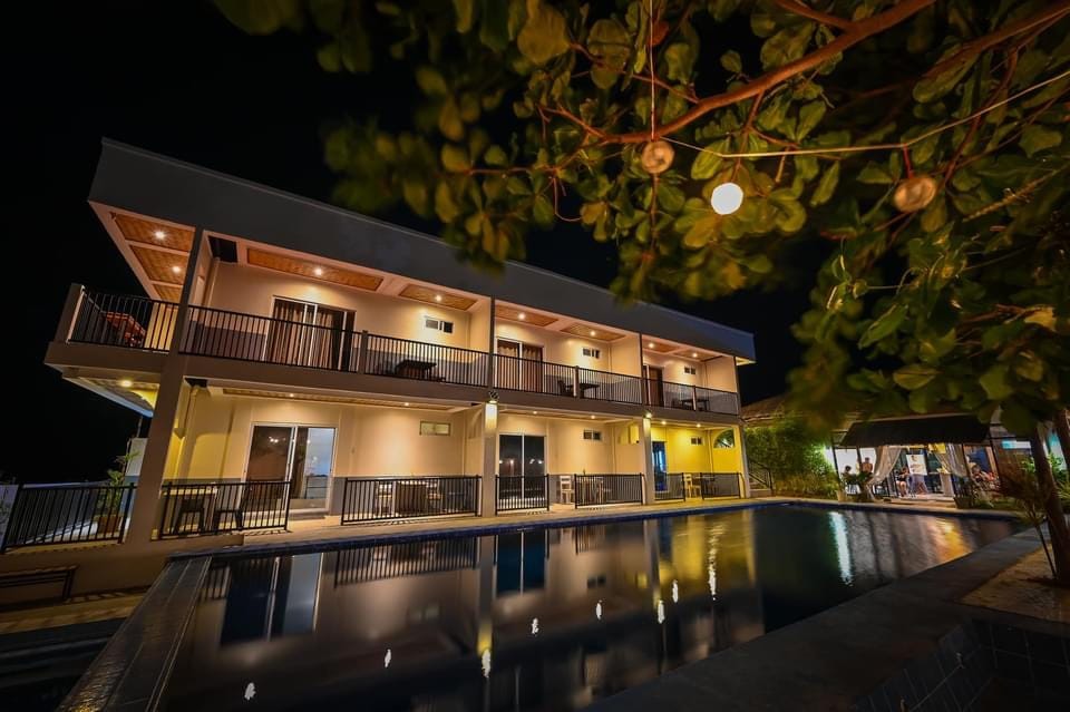 Night view of the building exterior from across the pool